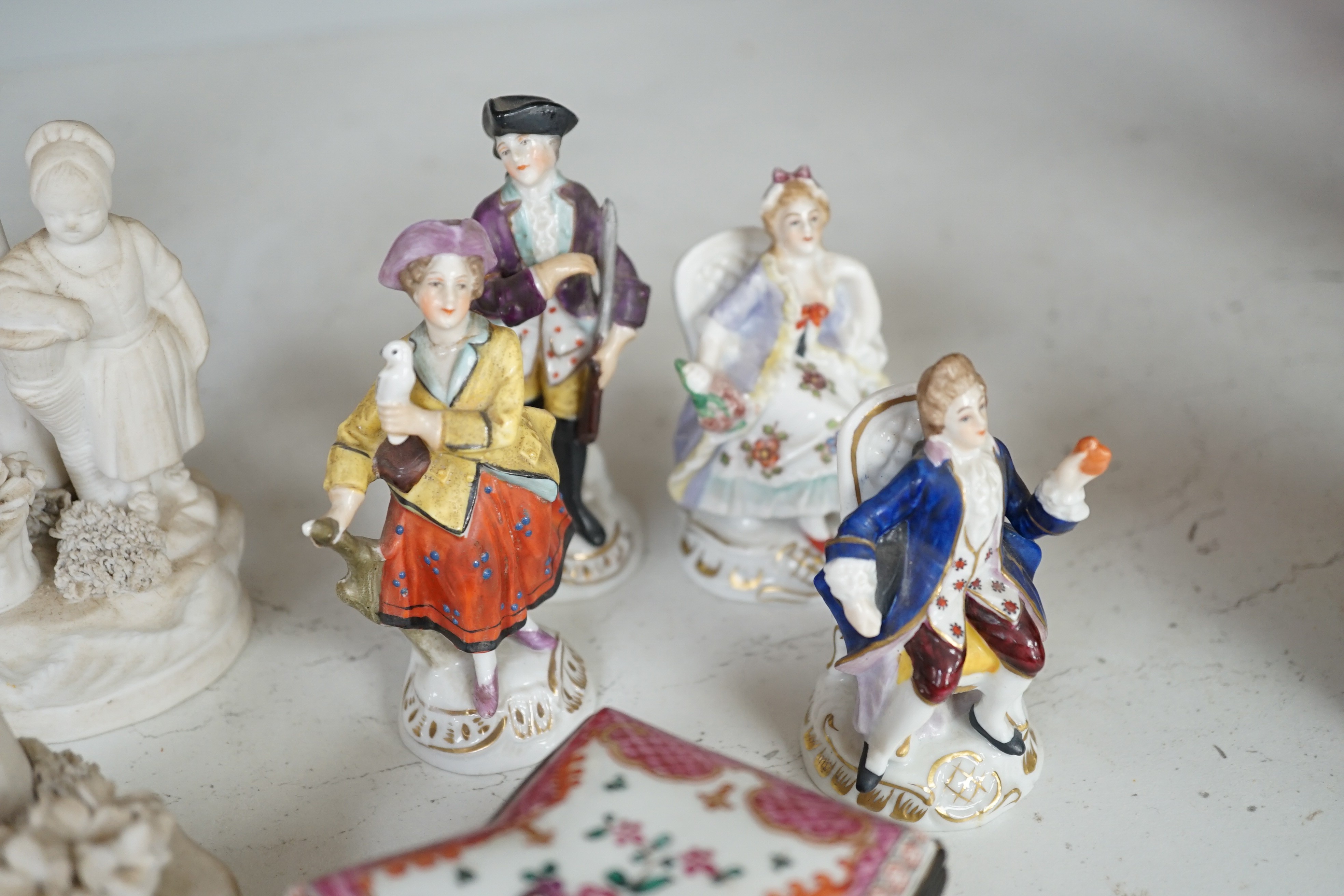 A pair of Hochst porcelain models of cows, 10.5cm long, a lidded box and other Continental figures